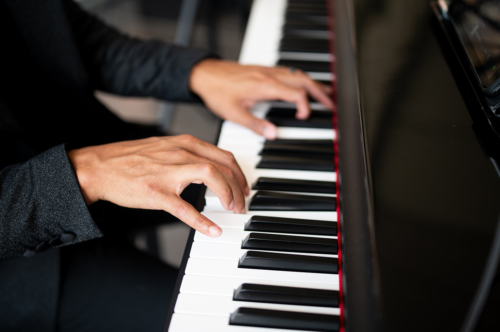 Close on Jerel Crockett's hands at the piano keys, composing